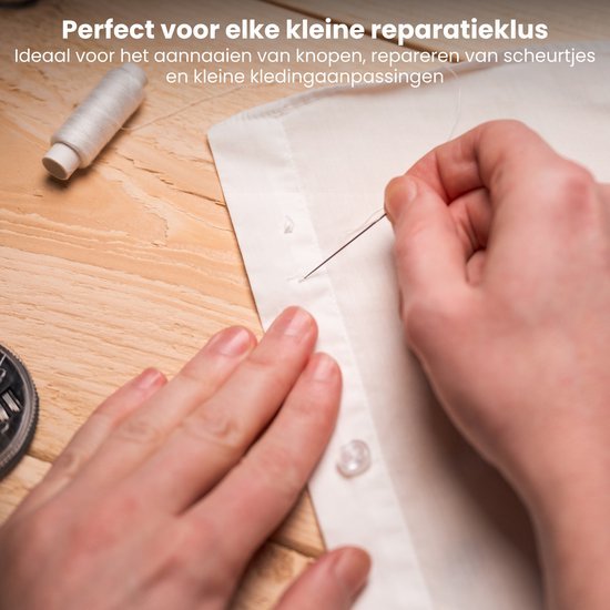 Hand naait knoop op wit kledingstuk met naaigaren en naaigerei op houten tafel