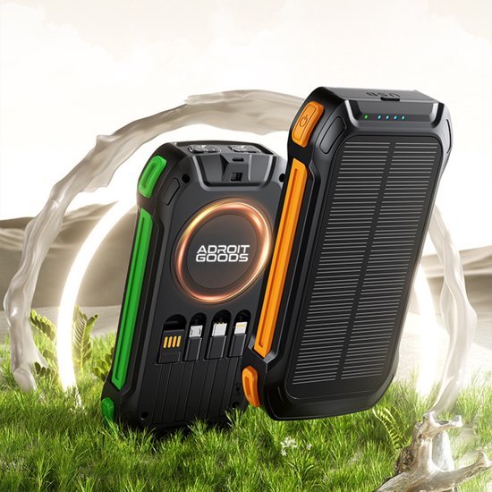 Draagbare zwarte en oranje powerbanks met AdroitGoods logo op gras met lichtcirkel achtergronddesign