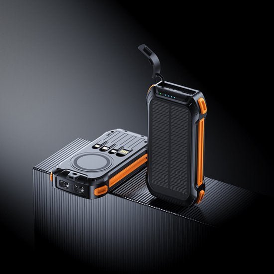 zwarte en oranje robuuste powerbanks met zonnepaneel en oplaadpoorten op zwart oppervlak