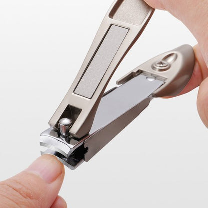 Close-up van hand die een metalen nagelknipper gebruikt om een nagel te knippen