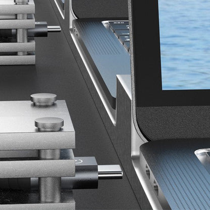 Close-up van een metalen apparaat aangesloten op een laptop via USB-verbinding naast waterachtergrond