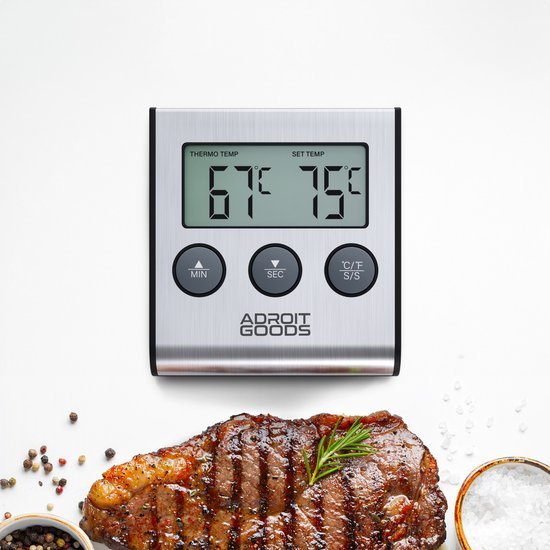 Digitale vleesthermometer met roestvrijstalen behuizing en gegrild stuk vlees eronder