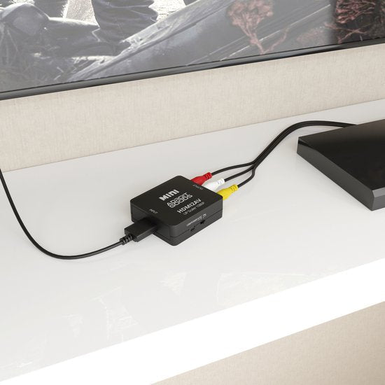 zwarte mini video converter met rood, geel en wit AV-kabels op een witte kast