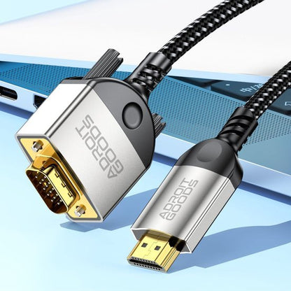 Zwarte gevlochten kabel met gouden VGA- en HDMI-connectoren naast een blauwe laptop