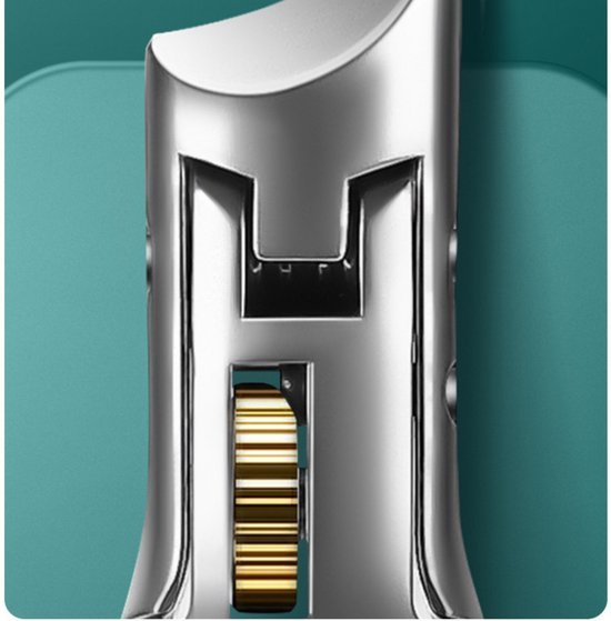 close-up van metalen mechanisch onderdeel met goudkleurig tandwiel op groene achtergrond