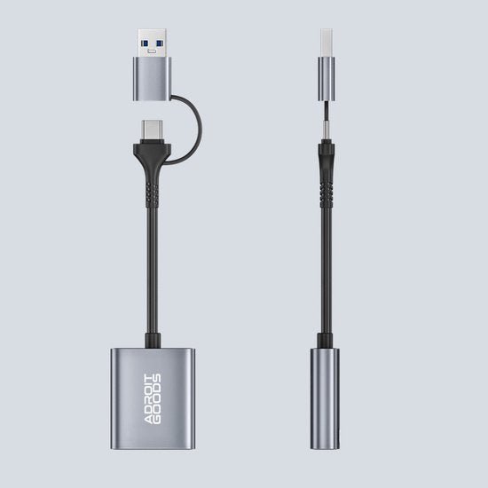 Zwarte en zilveren USB-adapter met verschillende aansluitingen voor gegevensoverdracht en opladen