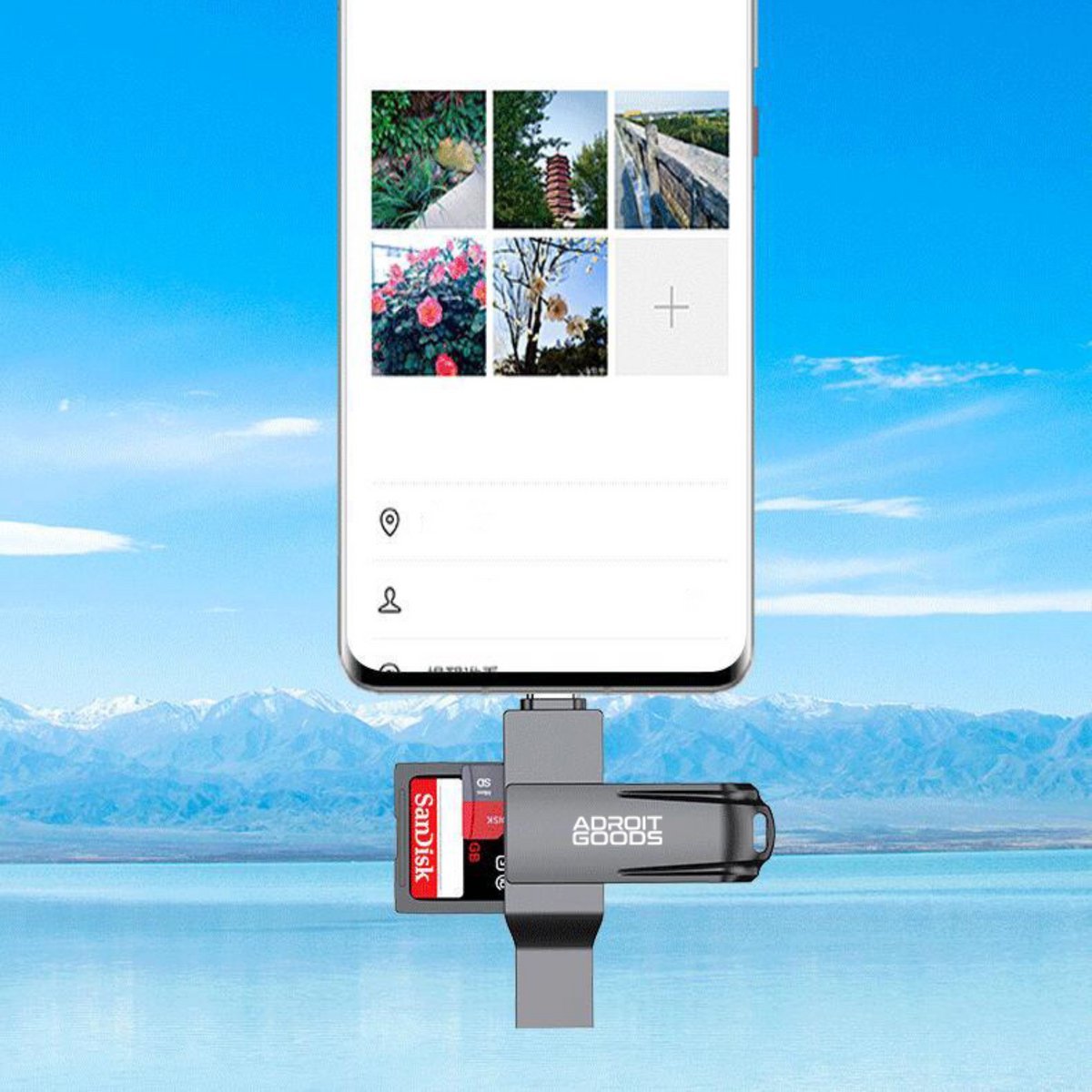 Zwarte AdroitGoods kaartlezer met SanDisk kaart aangesloten op smartphone met berglandschap op achtergrond