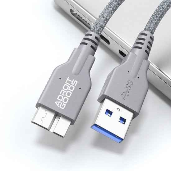 Grijze gevlochten USB 3.0-kabel met usb-a en micro-usb aansluitingen bij laptop