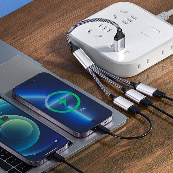 Meerdere apparaten opgeladen via een witte stekkerdoos met USB-snelkabels op houten tafel