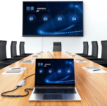 Moderne vergaderruimte met laptop en scherm die inhoud van presentatie tonen in blauw thema.