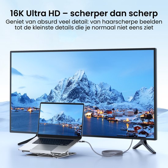 grote monitor en laptop met helder berglandschap en dorp in winterse omgeving