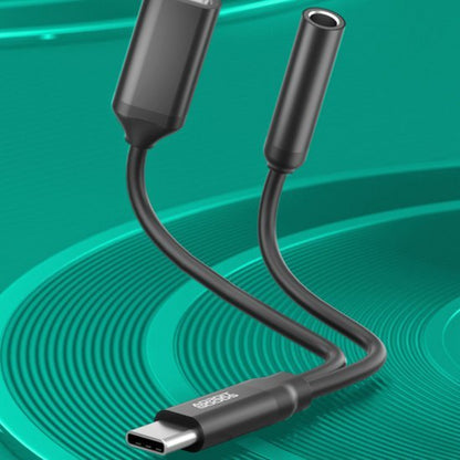 Zwarte USB-C kabel met twee aansluitingen op groene achtergrond met cirkelpatroon