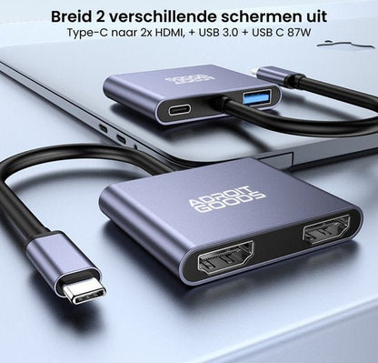 Grijs aluminium USB-C hub met dubbele HDMI-aansluiting en extra USB-poorten naast laptop