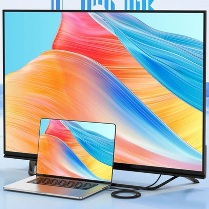 laptop verbonden met een extern scherm met kleurrijke golvende achtergrondpatronen