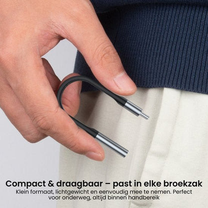 Hand houdt flexibel, compact hulpmiddel met metalen uiteinden tegen broekzak en trui